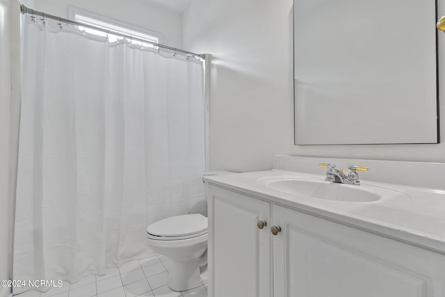 bathroom featuring tile patterned flooring, vanity, and toilet