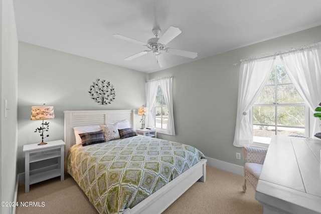 bedroom featuring carpet flooring, multiple windows, and ceiling fan