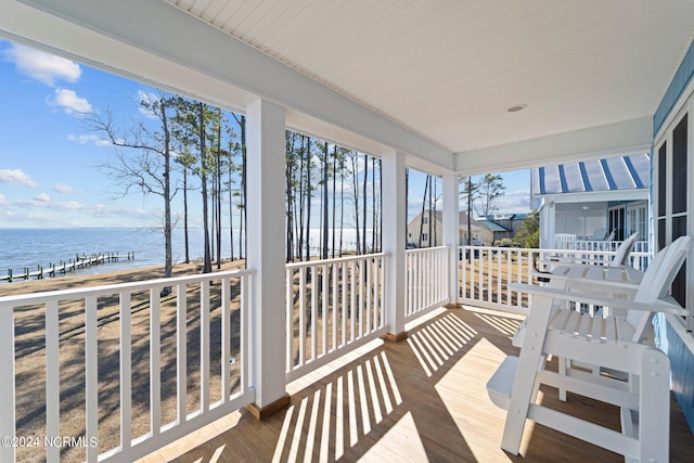 sunroom / solarium with a water view