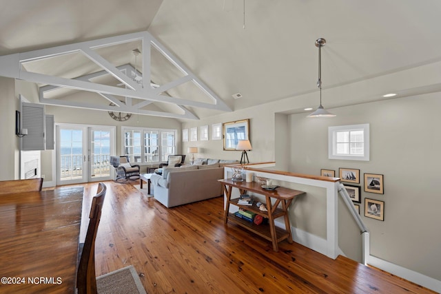 living room featuring plenty of natural light, french doors, and hardwood / wood-style flooring