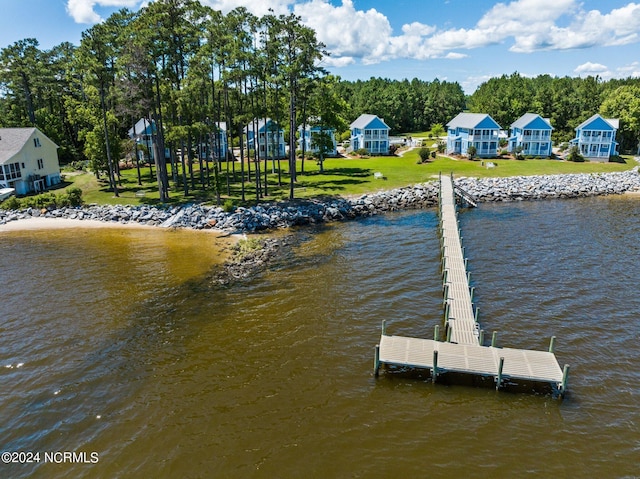 dock area featuring a yard and a water view