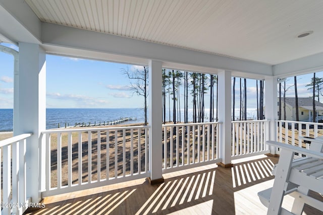 sunroom / solarium with a water view and plenty of natural light