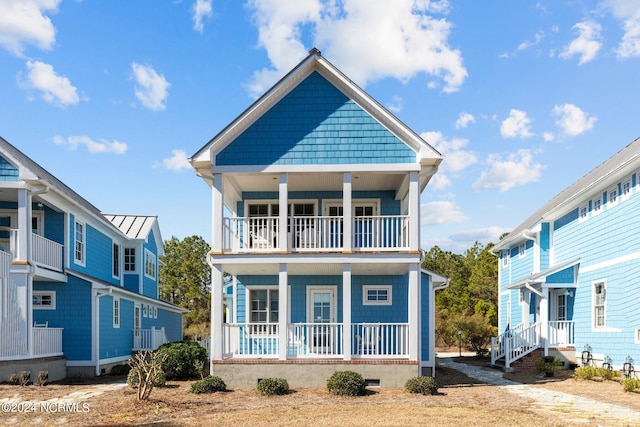 view of front of property featuring a porch and a balcony