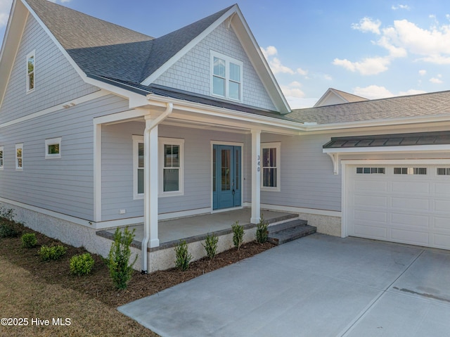 view of front of property with a garage and covered porch