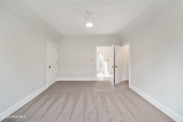 unfurnished bedroom with light colored carpet and ceiling fan