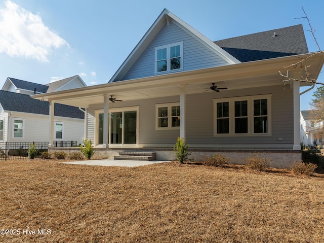 rear view of property with a lawn and ceiling fan