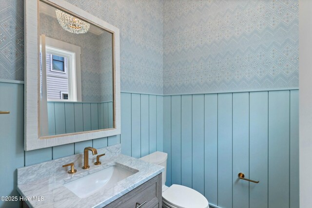 bathroom featuring vanity and tile walls