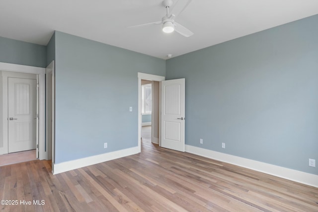 unfurnished bedroom featuring light wood finished floors, baseboards, and a ceiling fan