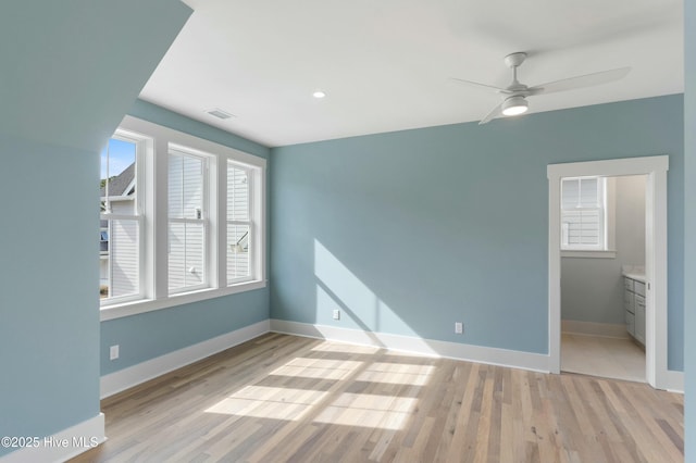 unfurnished bedroom with baseboards, ceiling fan, visible vents, and light wood finished floors