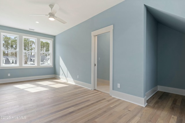 interior space with ceiling fan, wood finished floors, visible vents, and baseboards