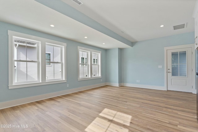 unfurnished room featuring light wood-style floors, baseboards, visible vents, and recessed lighting