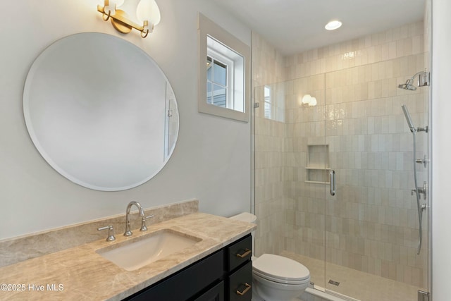 bathroom featuring a stall shower, vanity, toilet, and recessed lighting