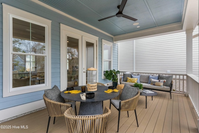 sunroom / solarium with a ceiling fan