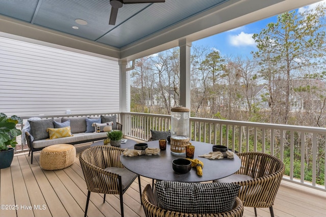 wooden deck featuring an outdoor hangout area and a ceiling fan