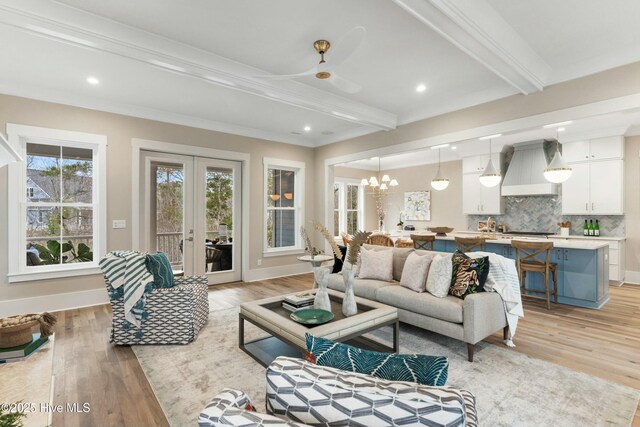 kitchen featuring a large island, white cabinetry, hanging light fixtures, high end white refrigerator, and custom exhaust hood