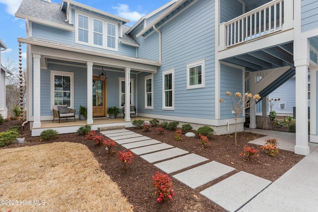 view of front of home featuring a shingled roof and a porch