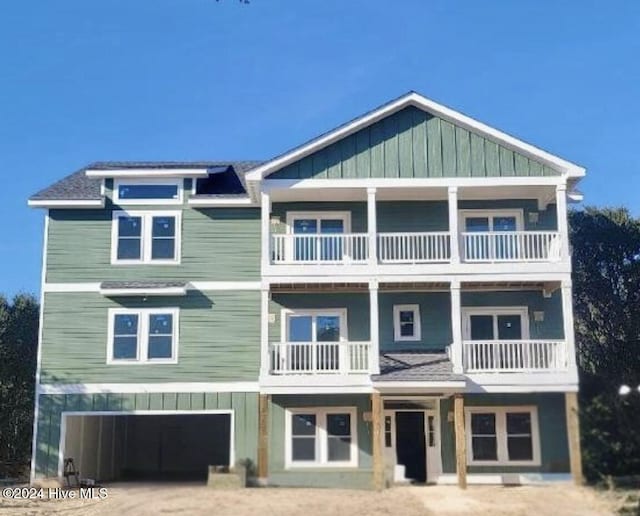 view of front of home featuring a garage and a balcony