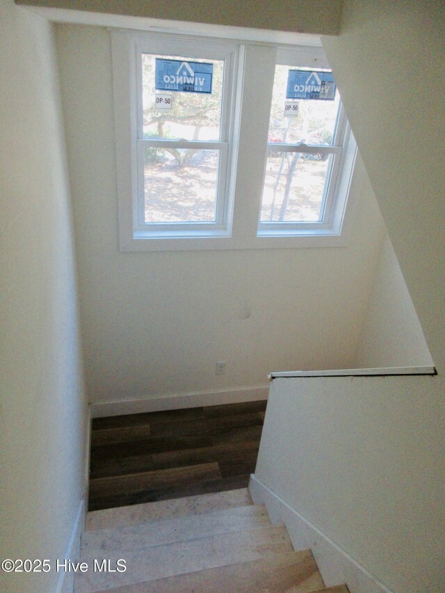 kitchen featuring dark wood-type flooring and white cabinets