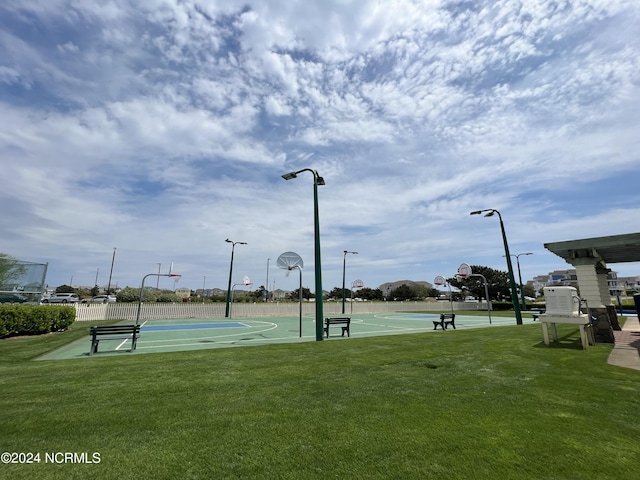 view of sport court featuring a yard