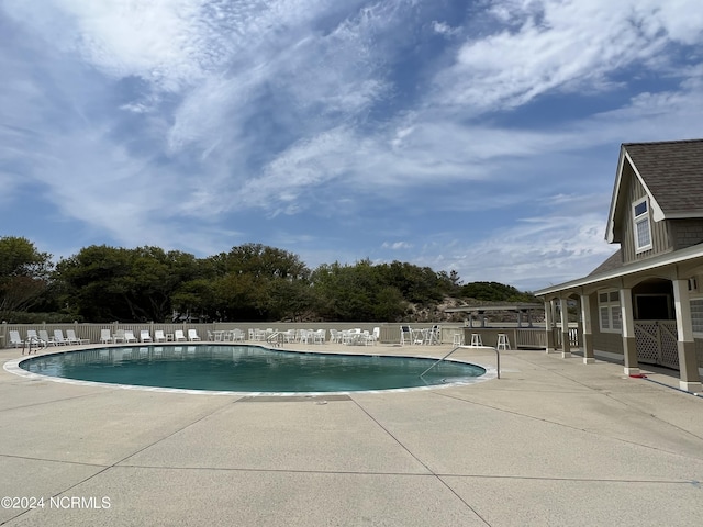 view of swimming pool with a patio