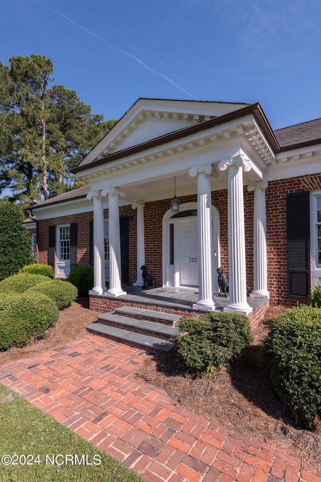 view of exterior entry with a porch