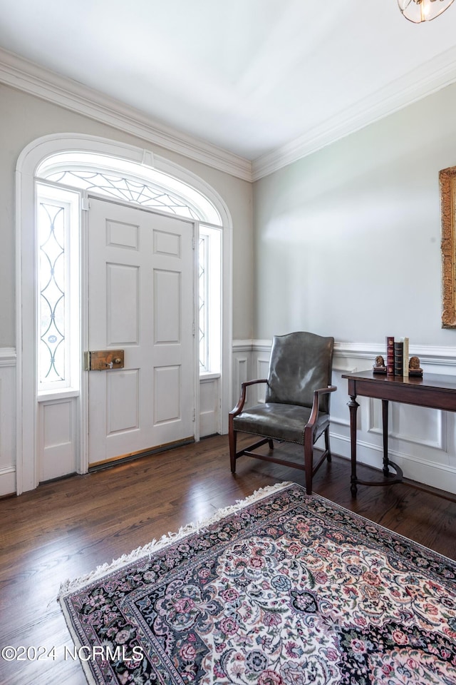 foyer entrance with dark wood-type flooring and ornamental molding