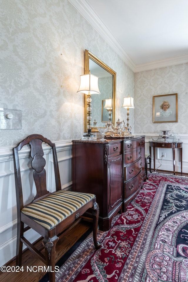 living area featuring crown molding