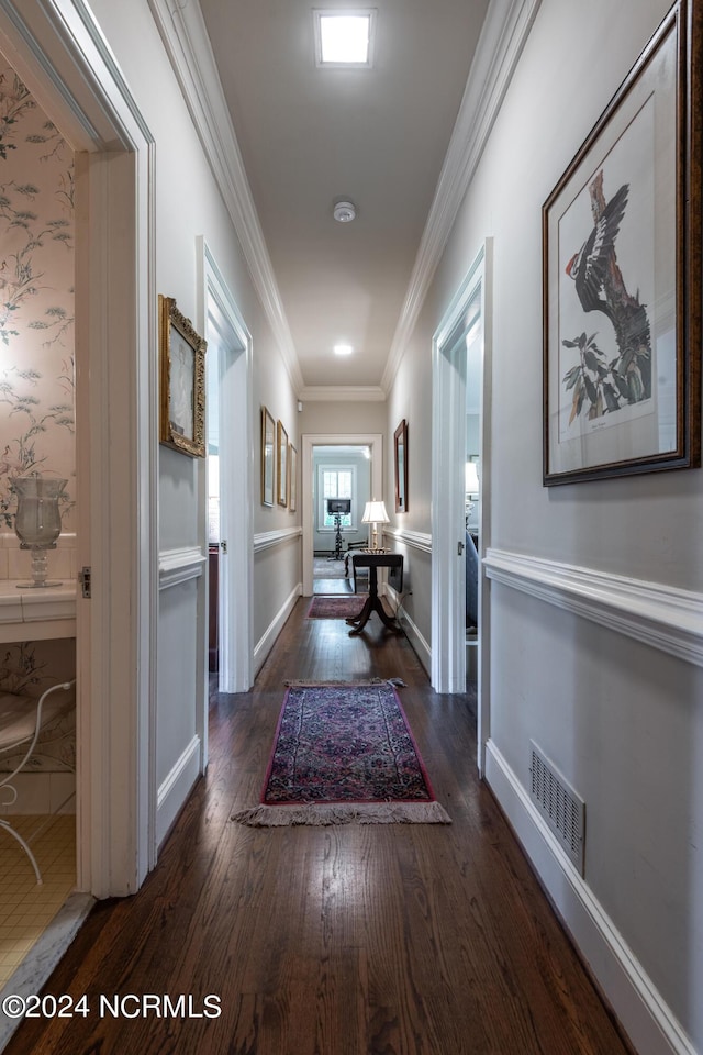 hallway featuring crown molding and dark hardwood / wood-style flooring