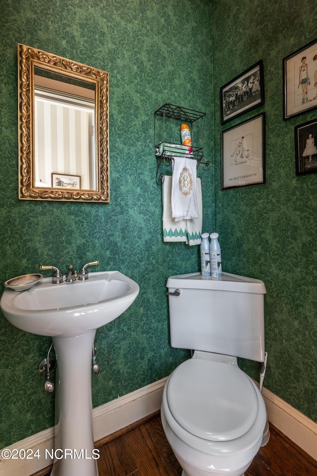 bathroom featuring hardwood / wood-style floors and toilet