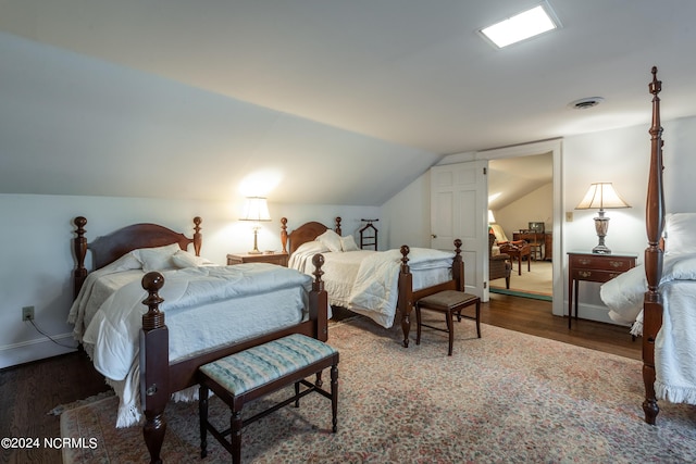 bedroom with wood-type flooring and lofted ceiling