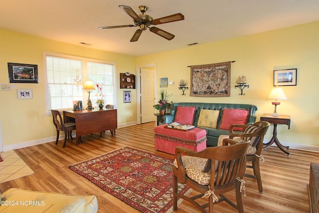 living room featuring hardwood / wood-style floors and ceiling fan