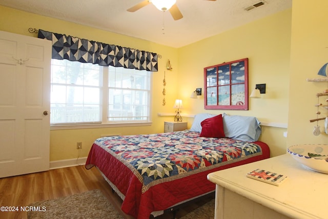 bedroom featuring wood-type flooring and ceiling fan