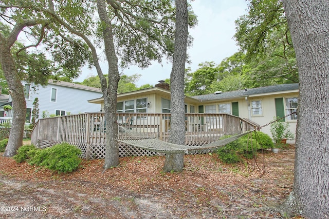 rear view of house featuring a wooden deck