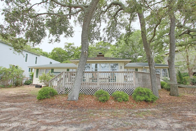 rear view of house featuring a deck