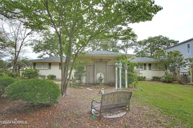 rear view of property with a lawn