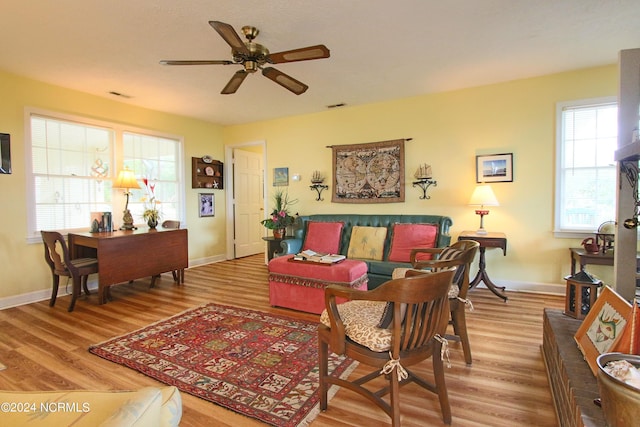 living room featuring wood-type flooring, a wealth of natural light, and ceiling fan