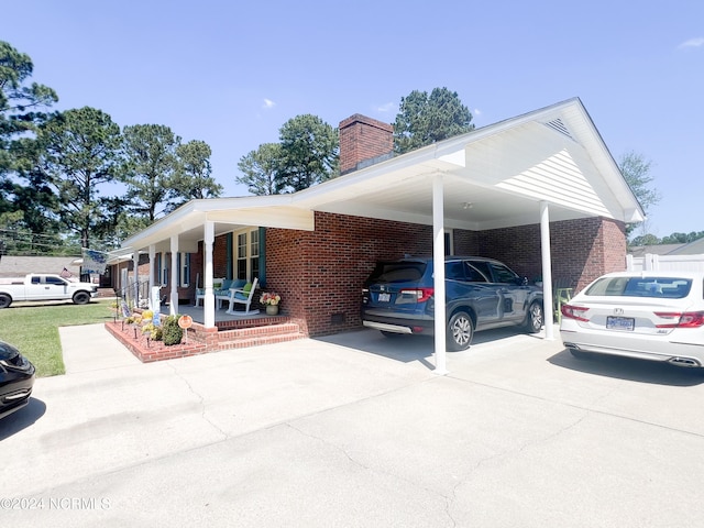 view of vehicle parking with a carport