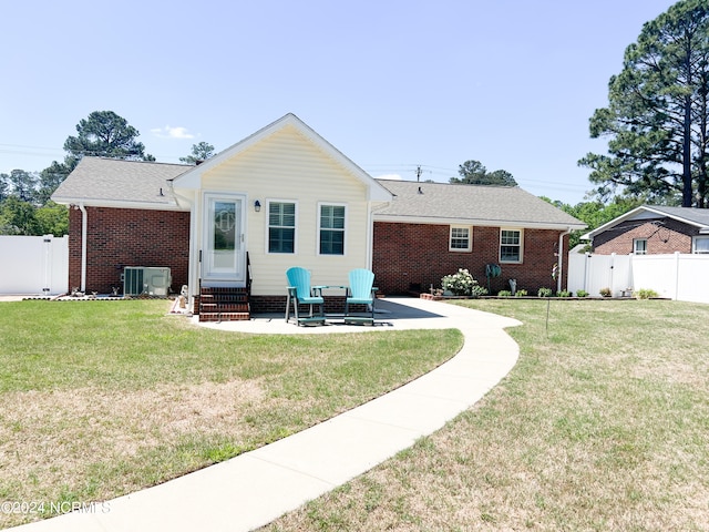 back of house featuring a patio, central air condition unit, and a yard