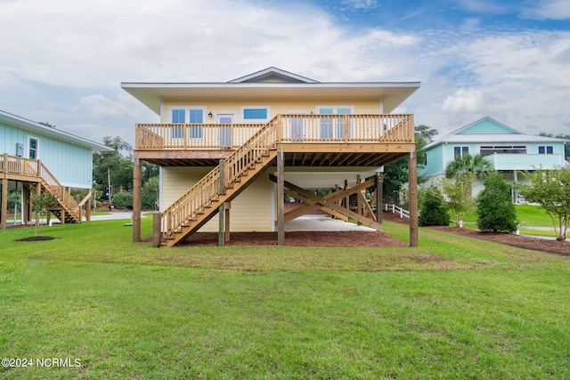 back of property featuring a lawn and a deck