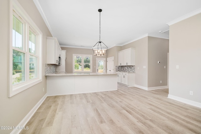 kitchen with decorative backsplash, white cabinets, light hardwood / wood-style floors, and kitchen peninsula