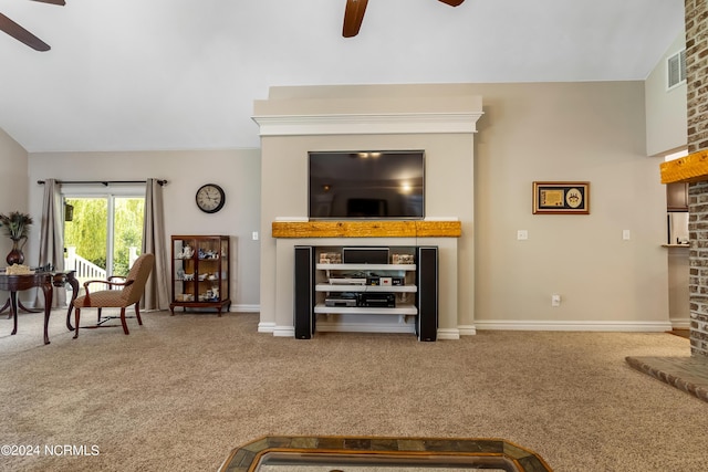 carpeted living room featuring lofted ceiling, a fireplace, visible vents, and a ceiling fan