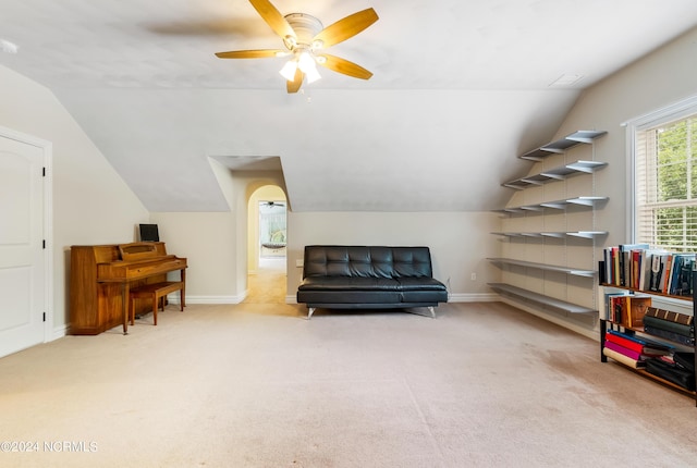 living area with lofted ceiling, ceiling fan, baseboards, and carpet flooring