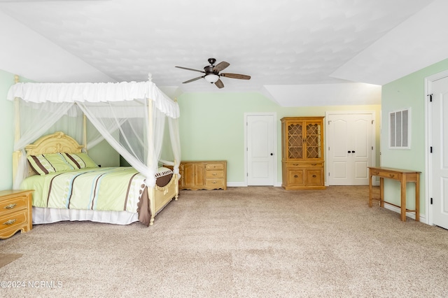 bedroom featuring lofted ceiling, ceiling fan, carpet flooring, visible vents, and baseboards