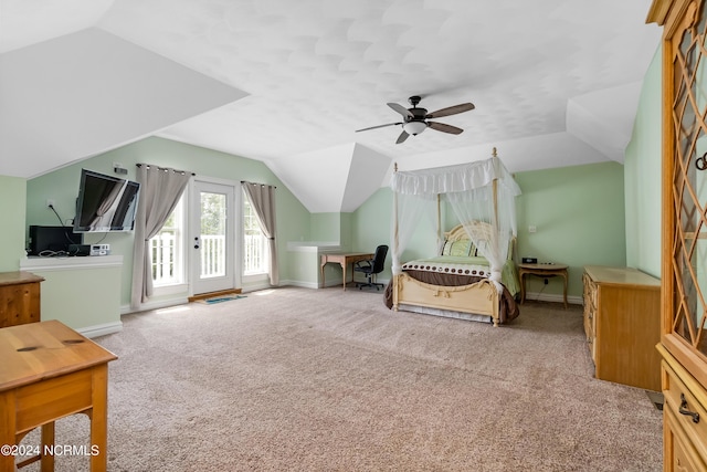 carpeted bedroom featuring access to outside, vaulted ceiling, and baseboards