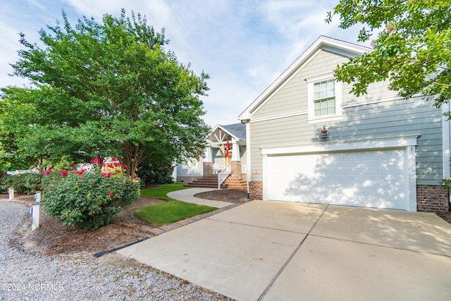 traditional home featuring a garage and driveway