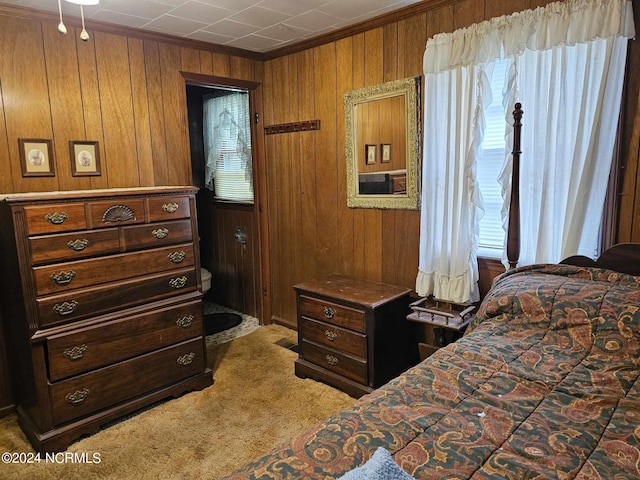 carpeted bedroom with wood walls