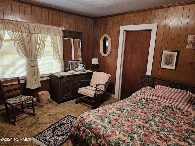 carpeted bedroom featuring wooden walls