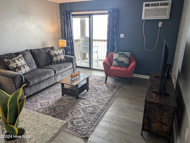 living room featuring hardwood / wood-style floors and a wall unit AC