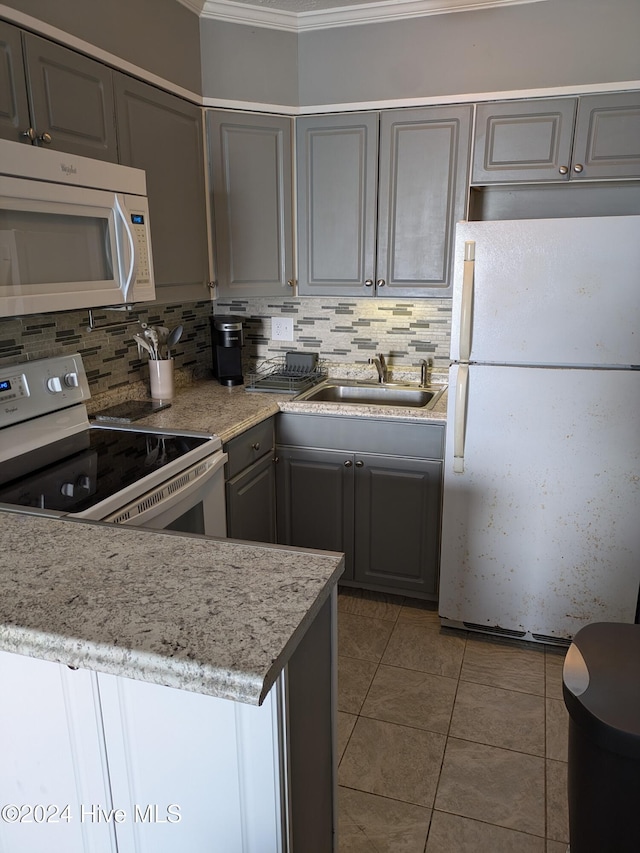 kitchen featuring white appliances, sink, decorative backsplash, and gray cabinetry