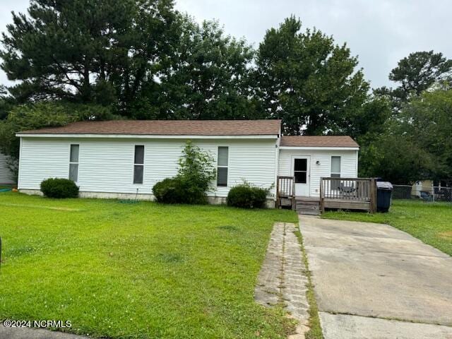 view of front of house with a wooden deck and a front lawn